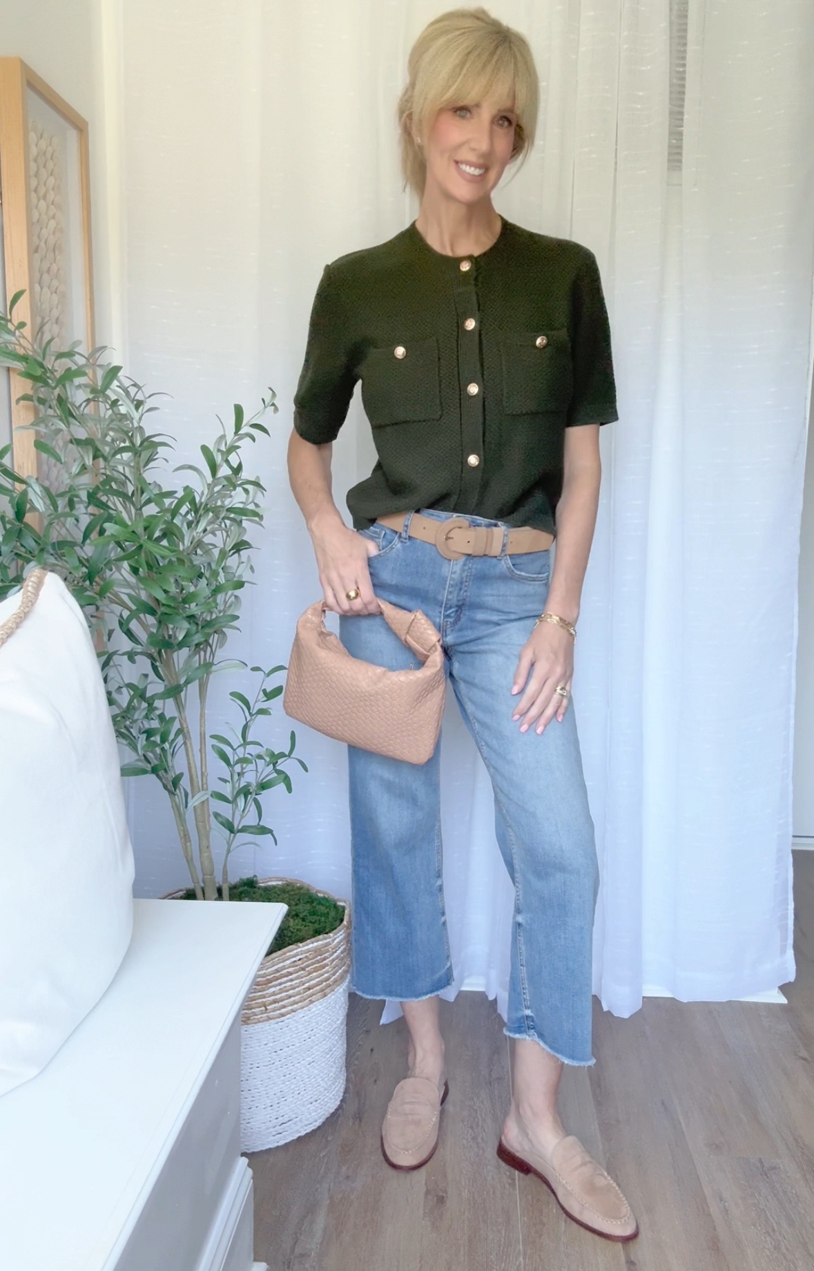 summer to fall transition outfit with a short sleeve lady cardigan, belt, loafer mules and handbag