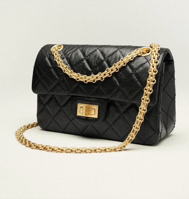 A black quilted Chanel 2.55 bag with gold hardware and a gold chain strap, designer look for less