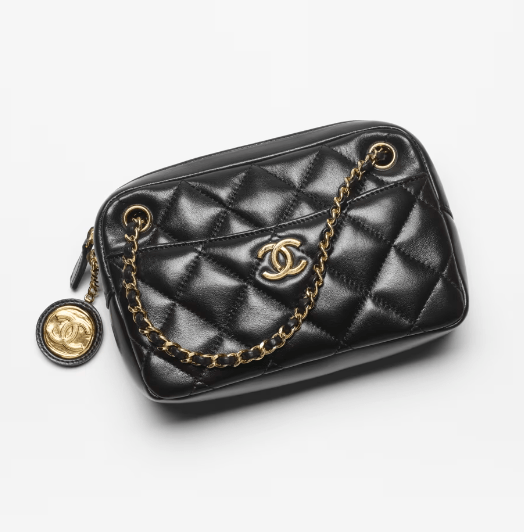 A black quilted Chanel crossbody bag with gold hardware and a gold chain strap.