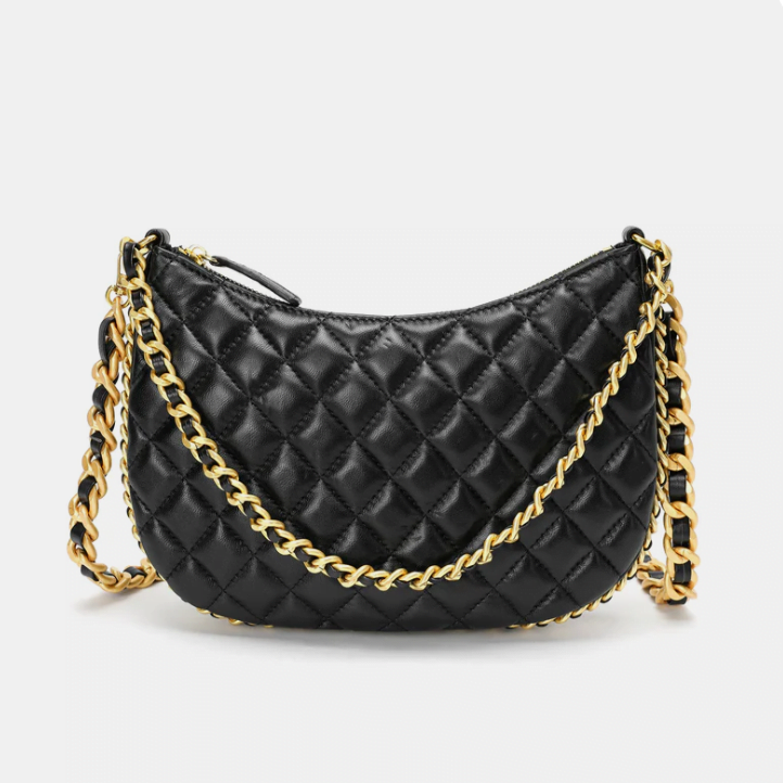 A black quilted crossbody bag with gold hardware and a gold chain strap.